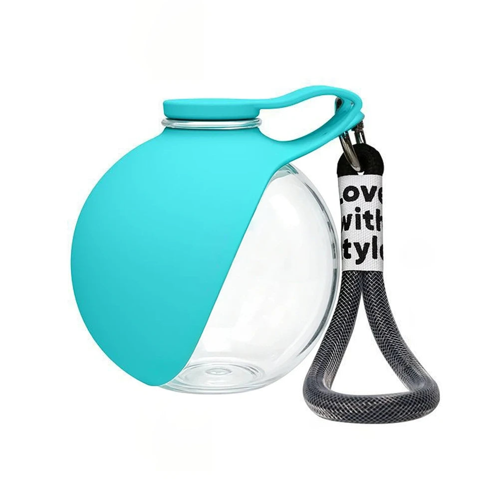 Teal portable pet water bottle with clear lower section and carry strap