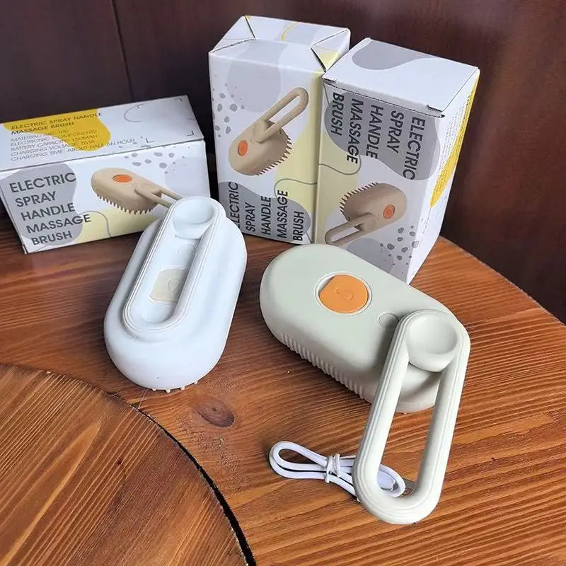 Electric steam grooming brush with white handle, orange pin head, and spray button on base